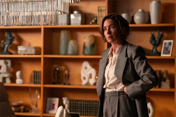 A woman stands in an office, looking thoughtful in "Paradise".