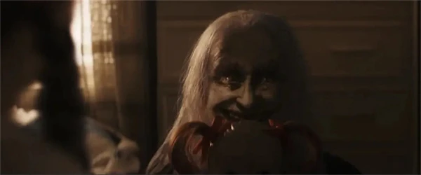 Creepy old ghost in "The Conjuring: Last Rites" with a sinister smile.