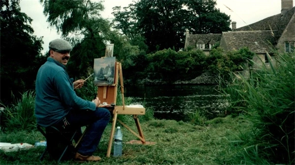 A man paints outdoors by a river in "Art For Everybody".