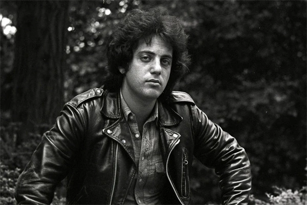 Billy Joel in a leather jacket outdoors in "Billy Joel: And So It Goes".