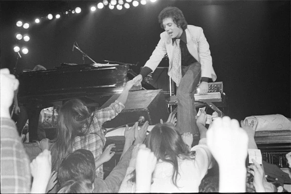Billy Joel performing live and interacting with fans in "Billy Joel: And So It Goes".