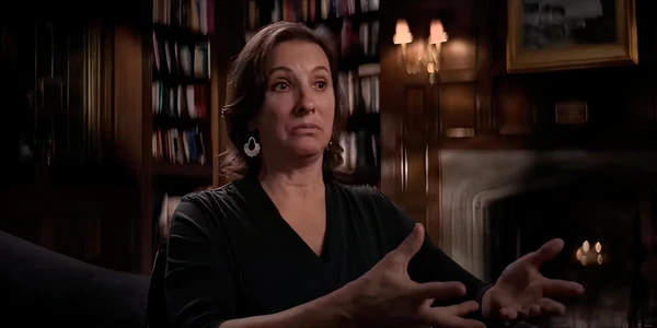 A woman gives an interview in a room filled with books in American Manhunt: Osama bin Laden.