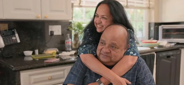 A couple shares a hug in the kitchen in "Love on the Spectrum U.S".